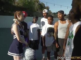 Cheerleader Teen Arietta Adams Blows a Group of Black adolescents